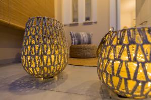 two yellow vases sitting on the floor in a room at Μπλε Rooms & Apartments in Chiliadou +49 photos