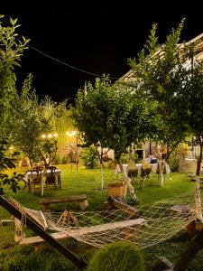 a garden at night with a fence and trees at Sheki Panorama Garden in Sheki