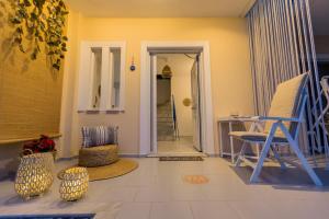a living room with blue chairs and a table at Μπλε Rooms & Apartments in Chiliadou