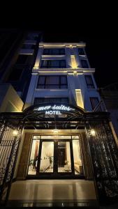 a hotel building with a sign on the front of it at Mer Suites Ha Long in Ha Long