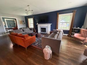 a living room with couches and a fireplace at The Legacy House in Topeka