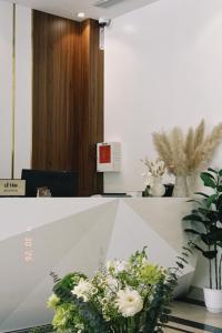 a table with a bunch of flowers on it at Mer Suites Ha Long in Ha Long