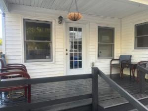 a porch with chairs and a table on a house at Ma Campagne in Lexington +3 photos