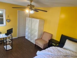 a bedroom with a bed and a chair and a ceiling fan at Ma Campagne in Lexington