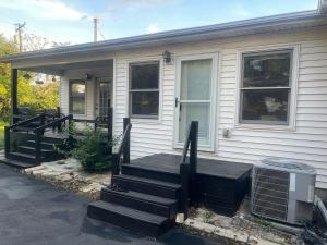a house with a porch with a wooden deck at Ma Campagne in Lexington