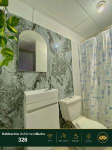 a bathroom with a sink and a toilet and a mirror at Hotel Grand ilama in Cali +79 photos