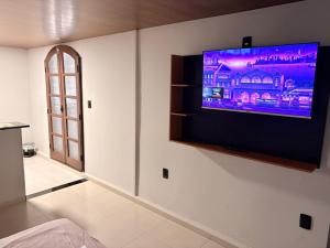 a flat screen tv on a wall in a room at Hotel Santo Antonio in Botucatu
