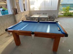 a pool table sitting in the middle of a patio at Pousada Costa Azul in Paulista