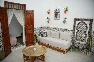 a living room with a couch and a table at Dar Mhani in Salé