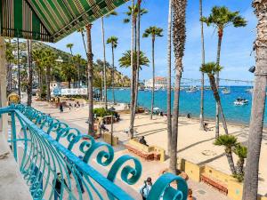 a view of a beach with palm trees and the ocean at The Edgewater in Avalon