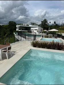a swimming pool in front of a building at Cocora Stay in Armenia