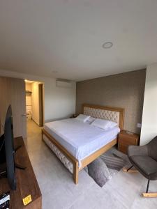 a bedroom with a bed and a desk and a television at Cocora Stay in Armenia +26 photos