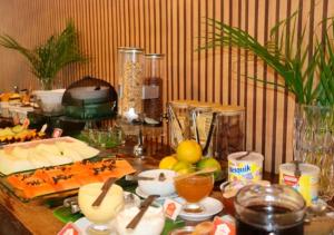 a table with some food on it with a table at Hotel Casa Encantada in Penedo
