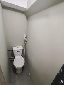 a small bathroom with a toilet in a stall at MG guest house in Geghanist
