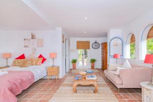 a bedroom with a bed and a couch and a table at "The Chill Pad In Cotobro A Boutique Style Studio Where Chillin Is Easy" in Almuñécar