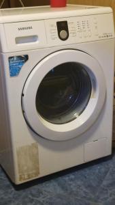 a white washing machine sitting on a counter at Guest House DEDA TINA in Mestia