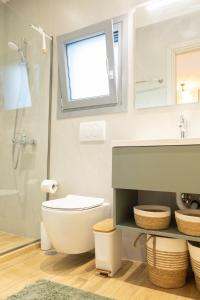 a bathroom with a toilet and a sink and a shower at Paul's Horizon in Chios +16 photos