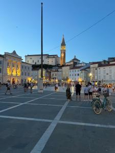 a city square with a clock tower in the background at La Dolce Vita in Piran