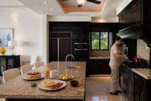 a man standing in a kitchen preparing food at Luxury Oceanview Penthouse in HDM in Punta Mita