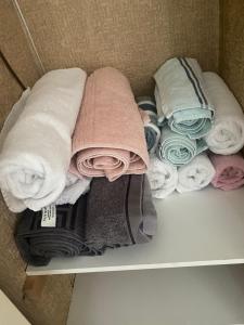 a pile of towels and towels on a shelf at The Nest Chelmsford in Chelmsford +25 photos