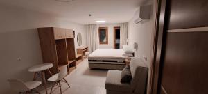 a bedroom with a bed and chairs in a room at Calm And Nature in Petra