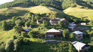 an aerial view of a village on a hill at Guest House DEDA TINA in Mestia