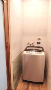 a washing machine in a corner of a room at Luxury Duplex Terrace and Grill in Ica +33 photos