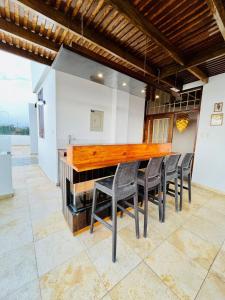 a kitchen with a wooden bar with chairs at Luxury Duplex Terrace and Grill in Ica