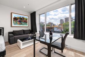 a living room with a table and a couch at Bonjour Plateau Hotel in Montreal