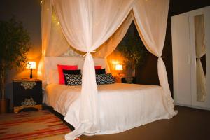 a bedroom with a white bed with a canopy at Casa Rural Julio in Terriente