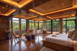a bedroom with a large bed in a room with windows at Hotel Parque España in Mexico City