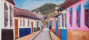 a painting of a street with colorful buildings at Hotel Apartasuite Normandia in Bogotá