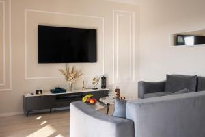 a living room with a flat screen tv on a wall at Villa Kleopatra in Međugorje