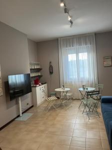 a living room with a tv and a table and chairs at B&B La Tenuta in Fermo