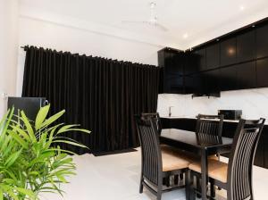 a black table and chairs in a room with plants at Nisansala Villa in Matara +47 photos