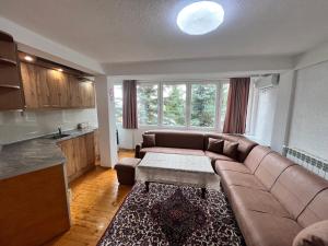 a living room with a couch and a table at Villa JETI in Tetovo