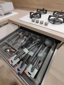 a drawer in a kitchen filled with cooking utensils at Il Rifugio del Re in Manfredonia