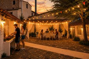 a group of people standing in a patio at night at Casa Rural Julio in Terriente