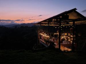 a gazebo with christmas lights on it at sunset at Alojamiento Las Rocas in Confines