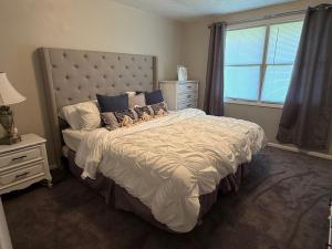 a bedroom with a large bed and a window at The Massillon Retreat! in Massillon