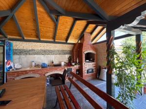 an outdoor kitchen with a brick oven in a house at Belareca Garden in Mehadia