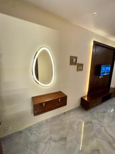 a room with a dresser and a mirror on a wall at Bella Boutique Hotel Near Centaurus Mall - LMY Hospitality Islamabad in Islamabad
