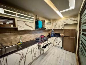 a large kitchen with a sink and a stove at Bella Boutique Hotel Near Centaurus Mall - LMY Hospitality Islamabad in Islamabad