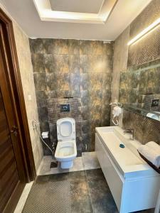 a bathroom with a toilet and a sink at Bella Boutique Hotel Near Centaurus Mall - LMY Hospitality Islamabad in Islamabad