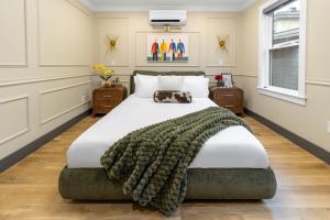 a bedroom with a large bed with a blanket on it at Cambridge Designer Home Harvard MIT Boston in Cambridge