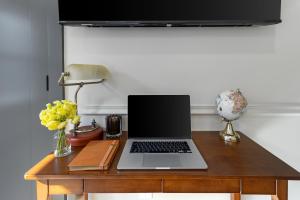 a laptop computer sitting on a wooden desk at Cambridge Designer Home Harvard MIT Boston in Cambridge