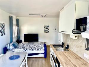 a small kitchen with a bed and a sink at Sea view avocado Finca Ten Days in La Orotava