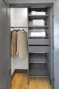 a walk in closet with black shelving at Cambridge Designer Home Harvard MIT Boston in Cambridge