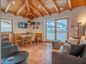 a living room with a couch and a table and chairs at IndieBerge in Mittersill