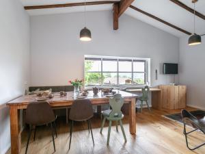 a dining room with a large wooden table and chairs at MAYR 74 in Wörgl
